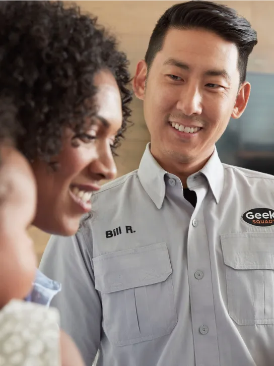 A Geek Squad agent smiles at a customer.